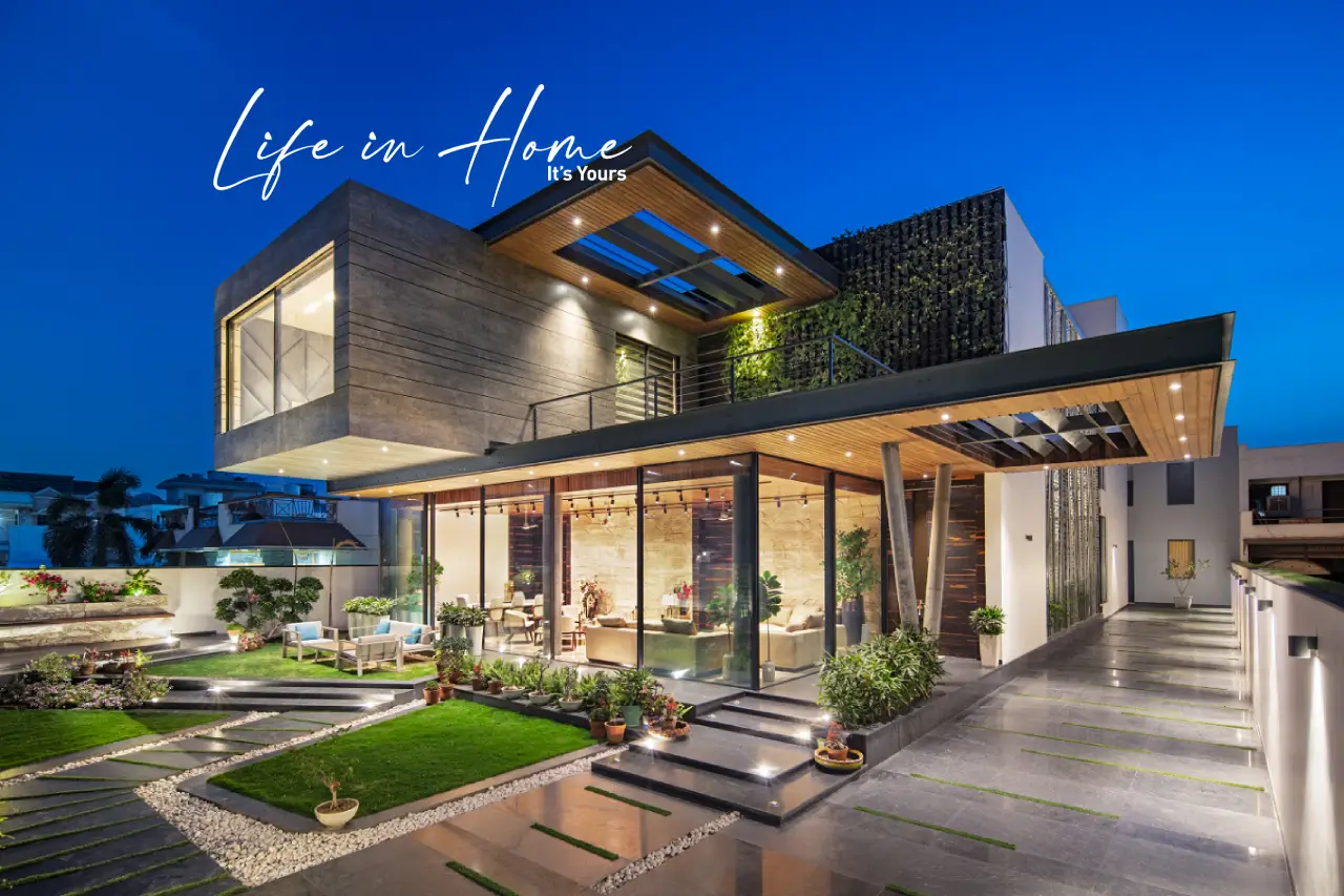 Luxury modern farmhouse with floor-to-ceiling glass walls and cantilevered roof—contemporary NRI home design in Narasimukku, Coimbatore.
