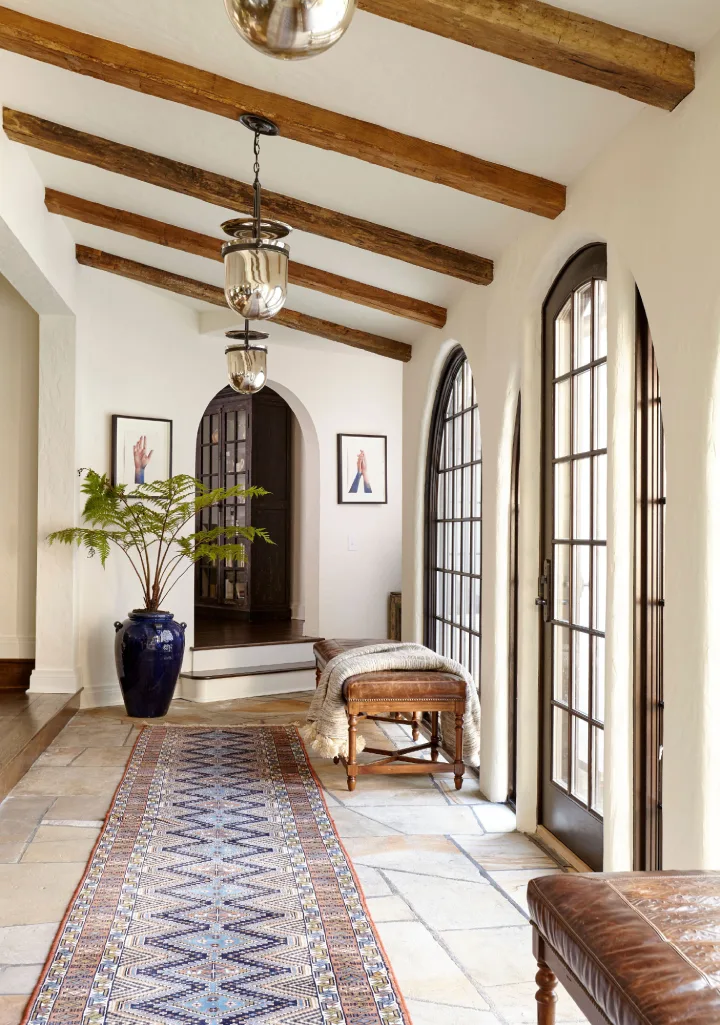 Minimalist Scandi-Zen foyer with light oak wood accents and an indoor olive tree—modern NRI vacation home in Coimbatore.