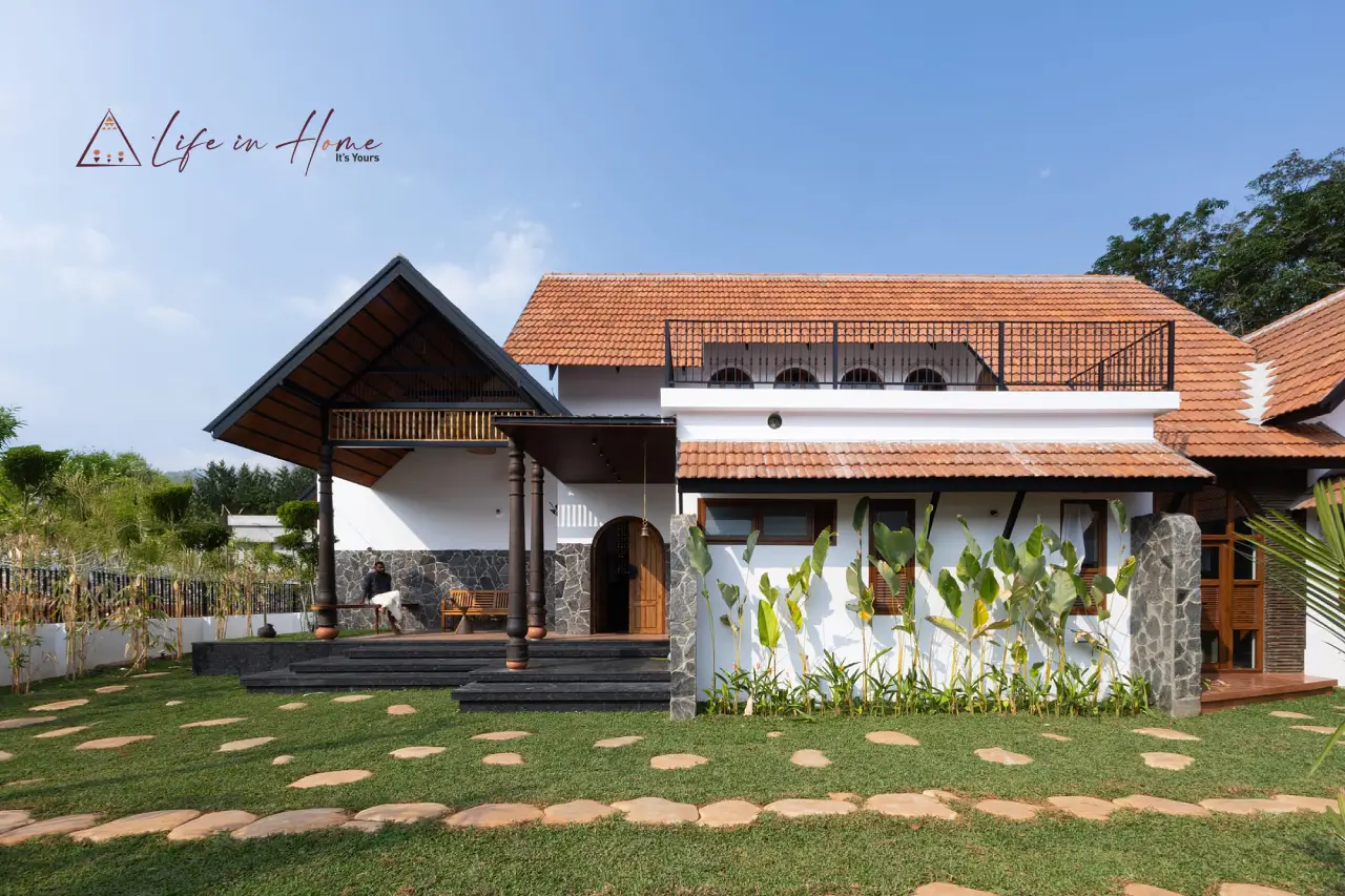 Traditional Kerala Nalukettu inspired farmhouse exterior with sloping tiled roofs for construction in Coimbatore and Palakkad.