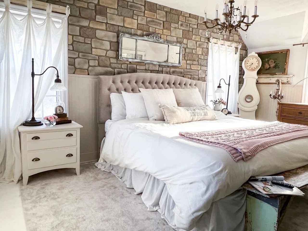 Rustic farmhouse bedroom featuring massive exposed timber beams and a natural stone accent wall—traditional retreat in Siruvani.