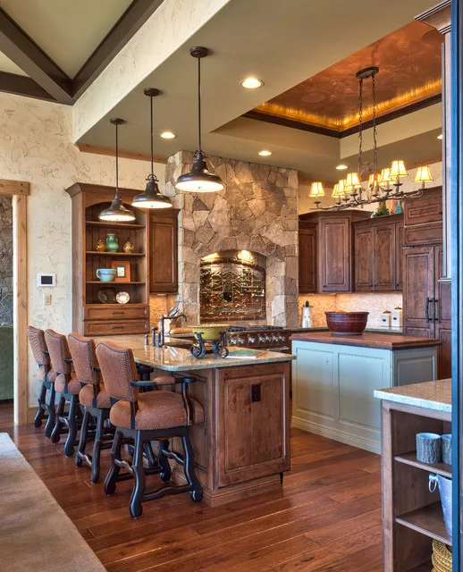 Rustic farmhouse kitchen featuring a natural stone backsplash, reclaimed wood cabinetry, and a deep fireclay farmhouse sink—traditional retreat in Siruvani.