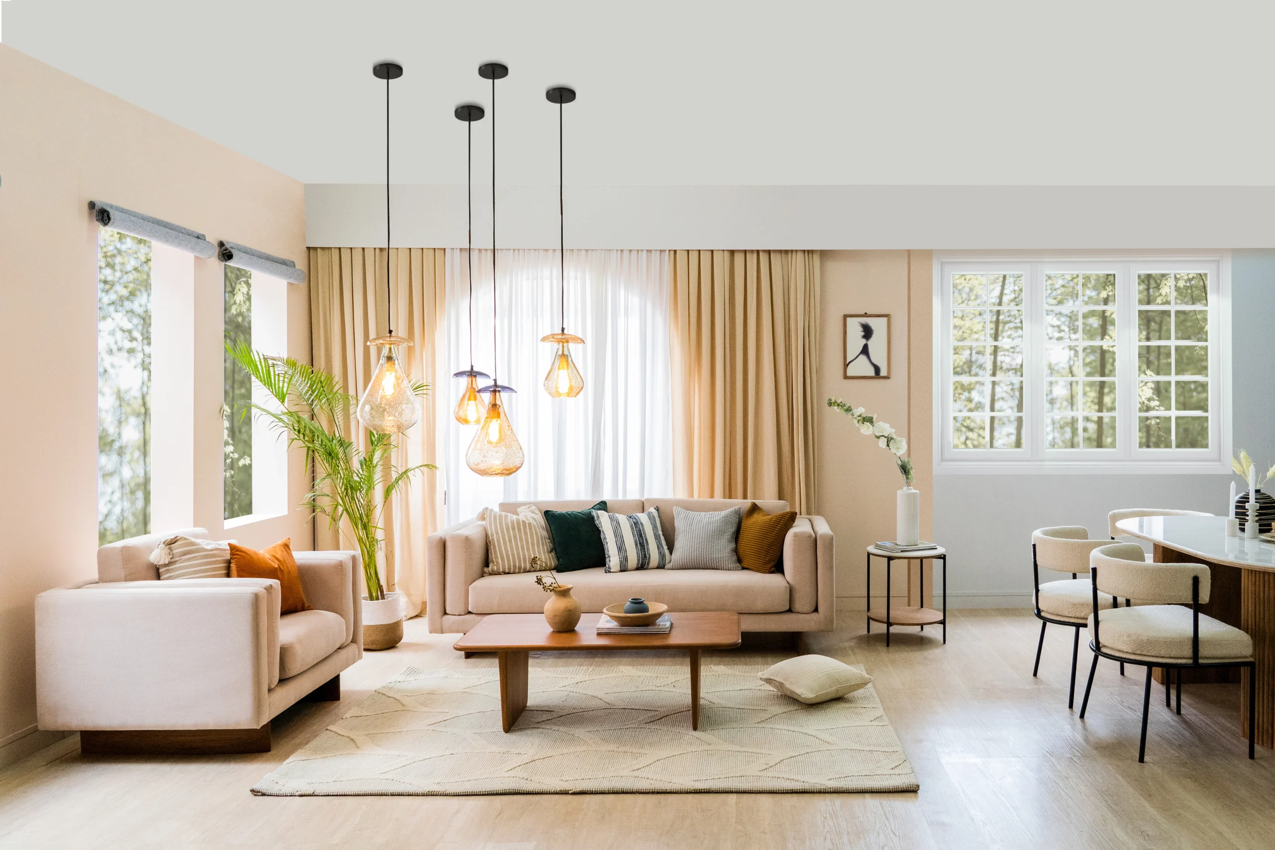 Minimalist Scandi-Hygge living room with neutral linen sofas, light oak wood floors, and indoor plants—modern NRI vacation home in Coimbatore.