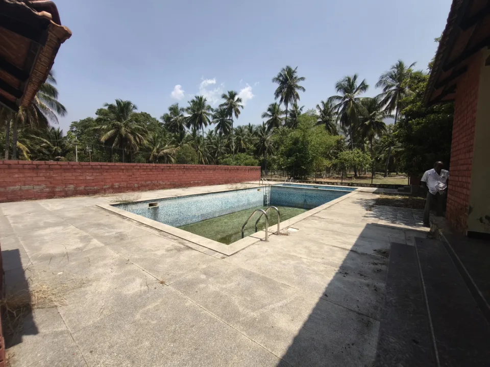 Luxury swimming pool in 23-acre coconut farm resort Pollachi.